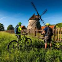 Cycling by a windmill in the Czech Republic | Petr Slavík