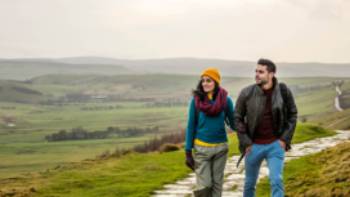 A happy couple following the Pennine Way trail in Derbyshire.