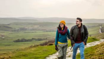 601257-56,Andrew Pickett A happy couple following the Pennine Way trail in Derbyshire.