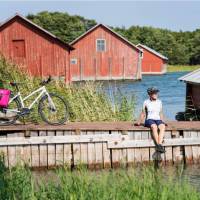 Cyclist taking a break while cycling between islands in Finland