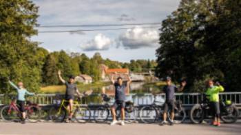 FIN Finland Coastal Route by Bike - Billsnas,The Travel Experience Cyclists on a bridge in Billnas on the Coastal Route