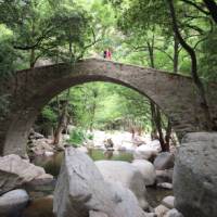 Crossing a magnificent stone bridge in Corsica | Kate Baker