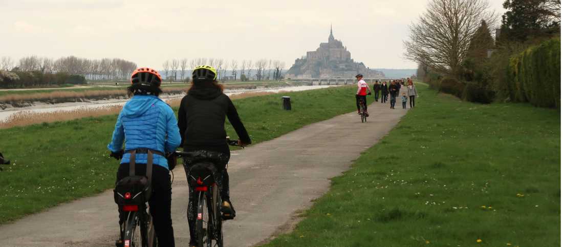 Cyclists and pedestrians en route to Mont St Michel in Normandy |  Kate Baker