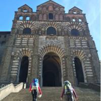 Hikers on the steps of the cathedral in Le Puy en Velay, the traditional start of the Way of St James | Kate Baker