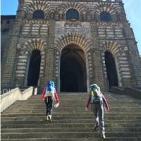 Hikers on the steps of the cathedral in Le Puy en Velay, the traditional start of the Way of St James | Kate Baker