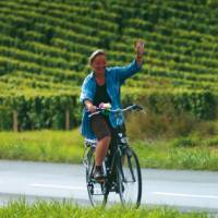 A local woman gives a welcoming wave, Loire Valley, France | Michael Gebicki