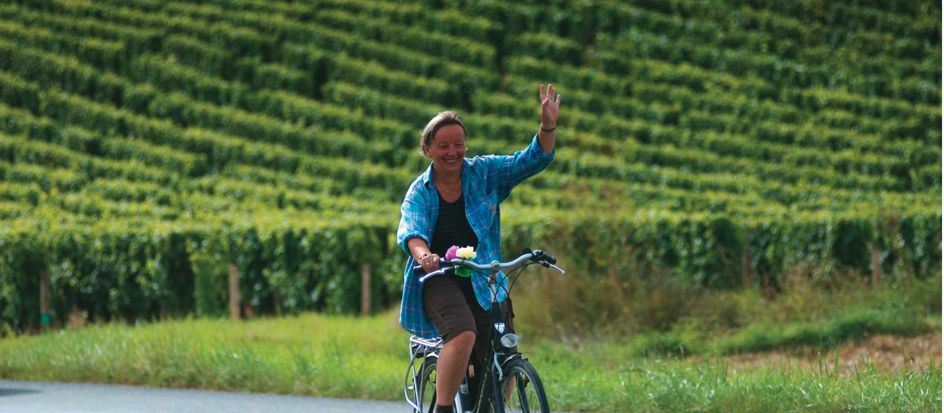 A local woman gives a welcoming wave, Loire Valley, France | Michael Gebicki