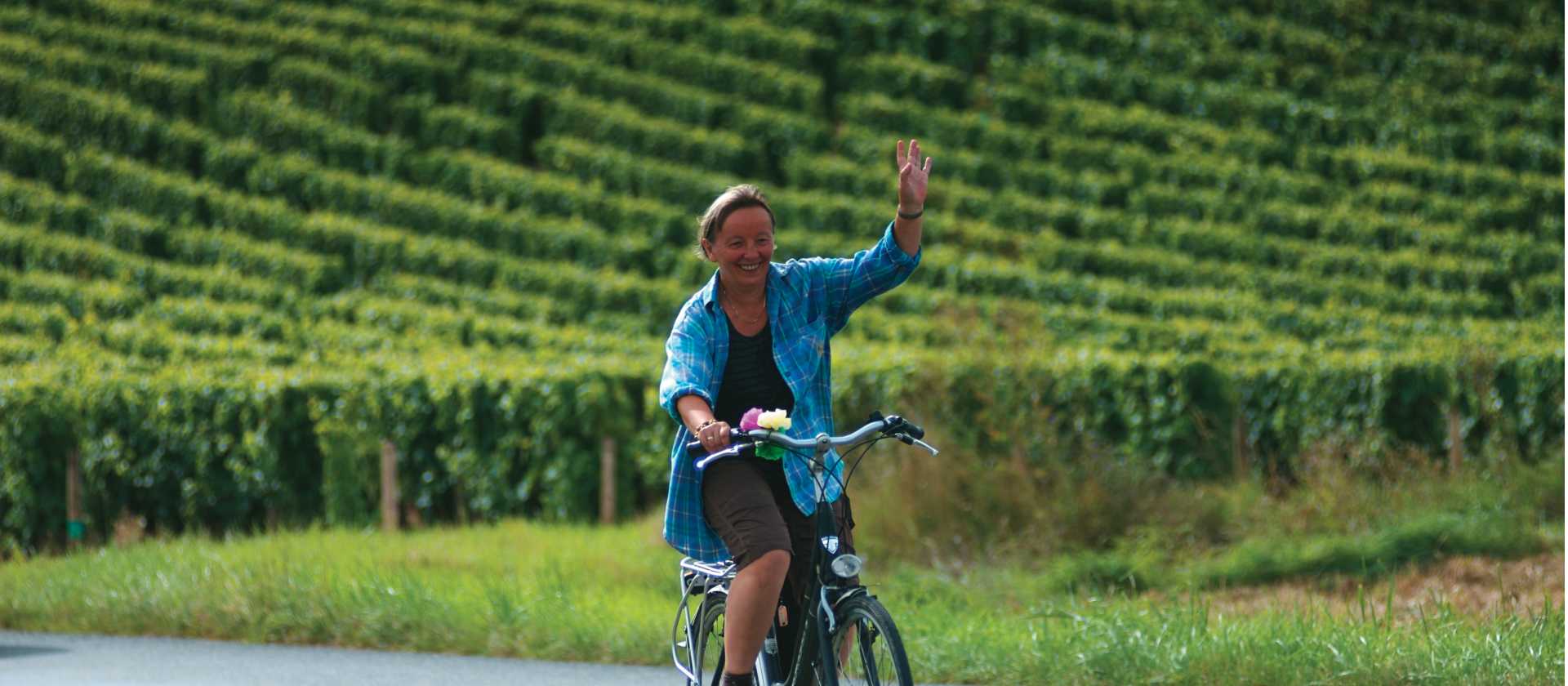 A local woman gives a welcoming wave, Loire Valley, France | Michael Gebicki