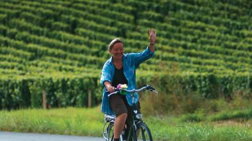 A local woman gives a welcoming wave, Loire Valley, France | Michael Gebicki