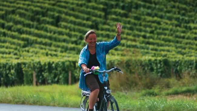 A local woman gives a welcoming wave, Loire Valley, France | Michael Gebicki