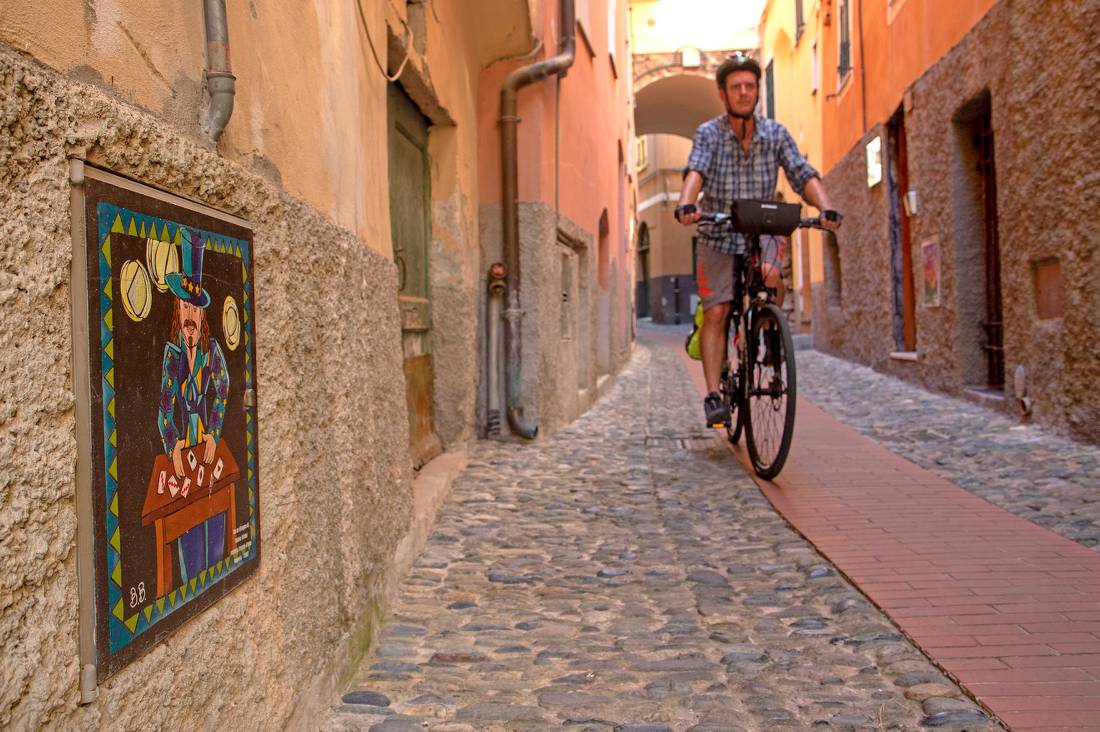 Cyclist exploring the cobbled town of Civezza on the Nice to Genoa Cycle |  <i>Andrew Bain</i>
