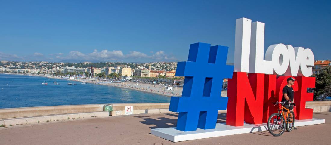 Cyclist posing for a photo in Nice, the starting point of the Nice to Genoa Cycle |  <i>Andrew Bain</i>