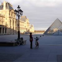 Cyclist at the Louvre in Paris | Kate Baker