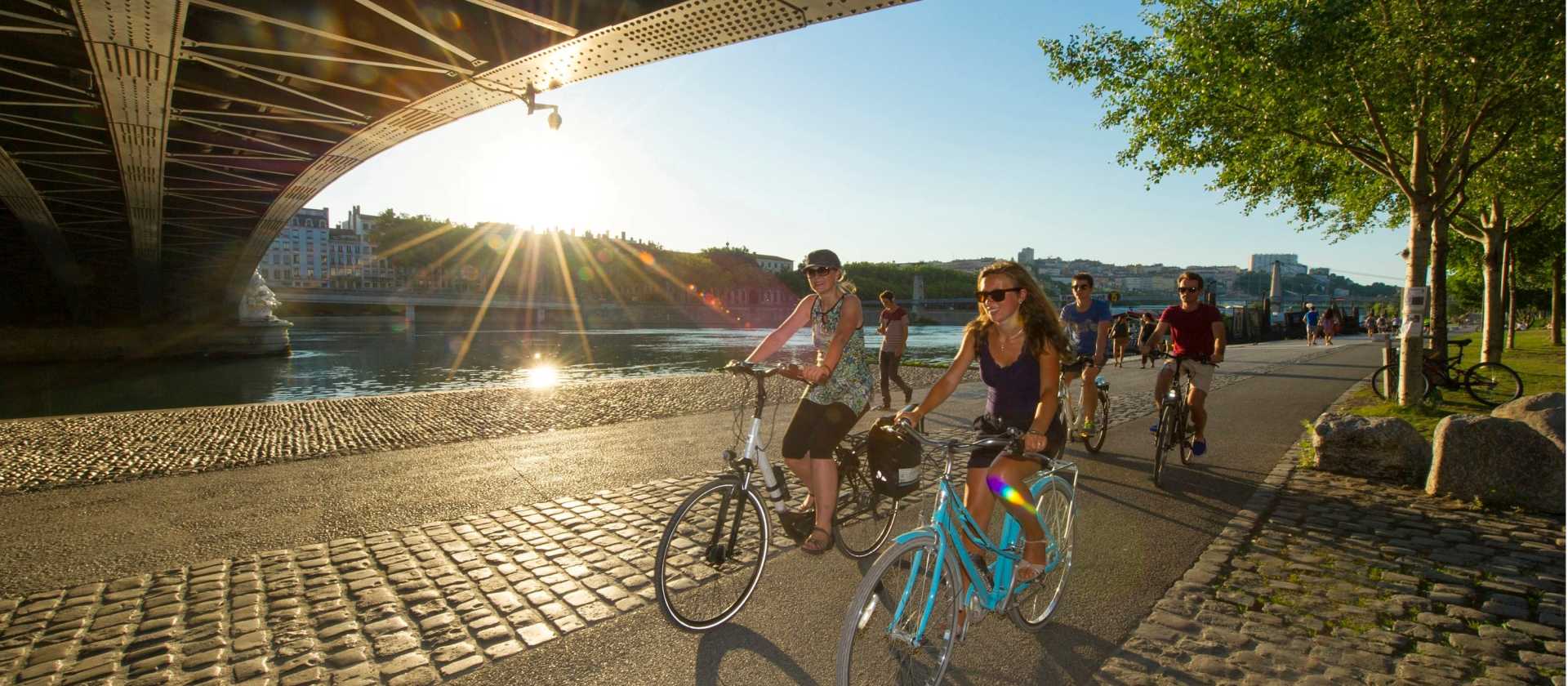 Cycling beneath one of the many bridges spanning the Rhone River in Lyon