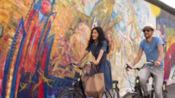 Cycling along Berlin's East Side Gallery