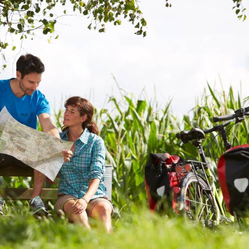 Consulting a map while on a self-guided cycle tour in Germany