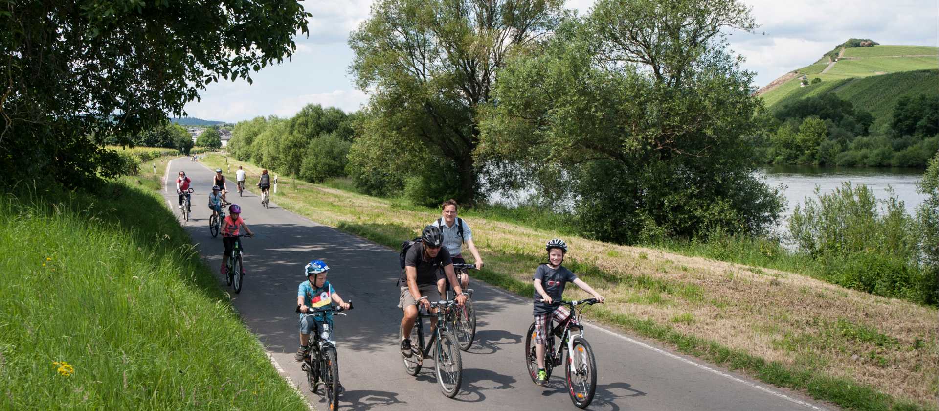 Family cycling along the Moselle Bike Path in Germany