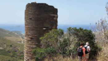 Hikers pass a Hellenistic Tower on the Andros Trail Self Guided Walk