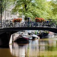 Bikes line the bridge over a canal in Amsterdam