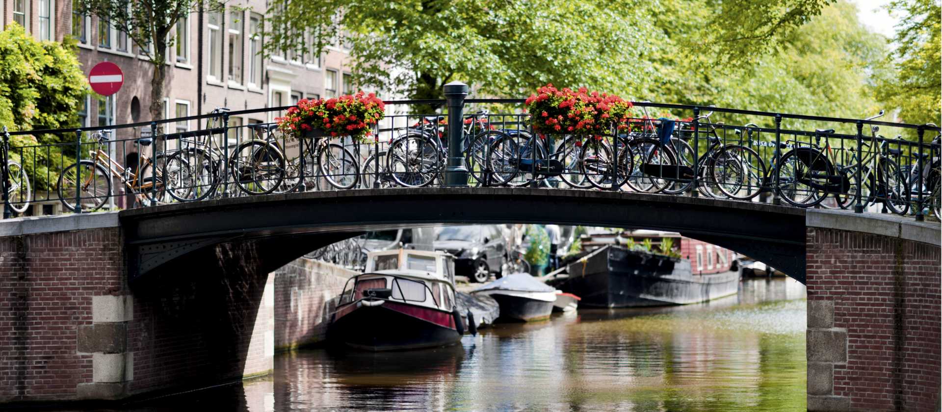 Bikes line the bridge over a canal in Amsterdam