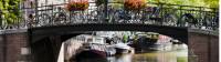 Bikes line the bridge over a canal in Amsterdam