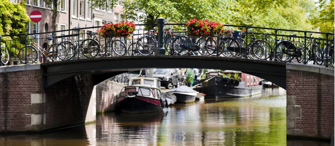 Bikes line the bridge over a canal in Amsterdam