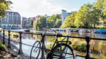 Park your bike alongside a Dutch canal in Amsterdam