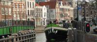 A barge with cyclists navigating the canals outside of Amsterdam | Richard Tulloch