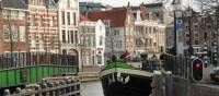 A barge with cyclists navigating the canals outside of Amsterdam | Richard Tulloch