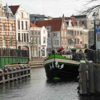 A barge with cyclists navigating the canals outside of Amsterdam | Richard Tulloch