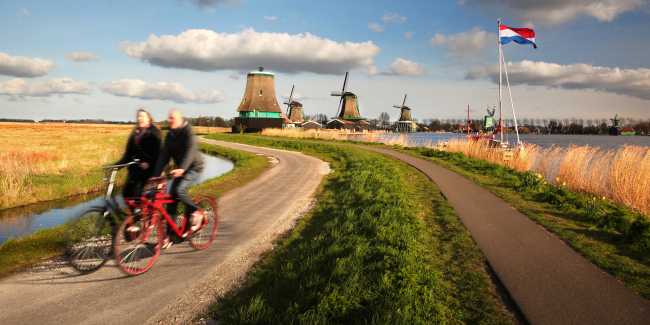 Cycling past windmills in Holland
