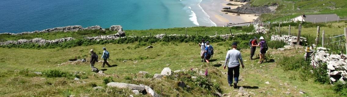 Hikers walking down to Coumeenoole Bay, Dingle
