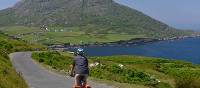 Cyclists on the west Cork coastline with rolling hills and stunning coastline