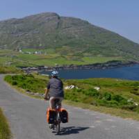 Cyclists on the west Cork coastline with rolling hills and stunning coastline