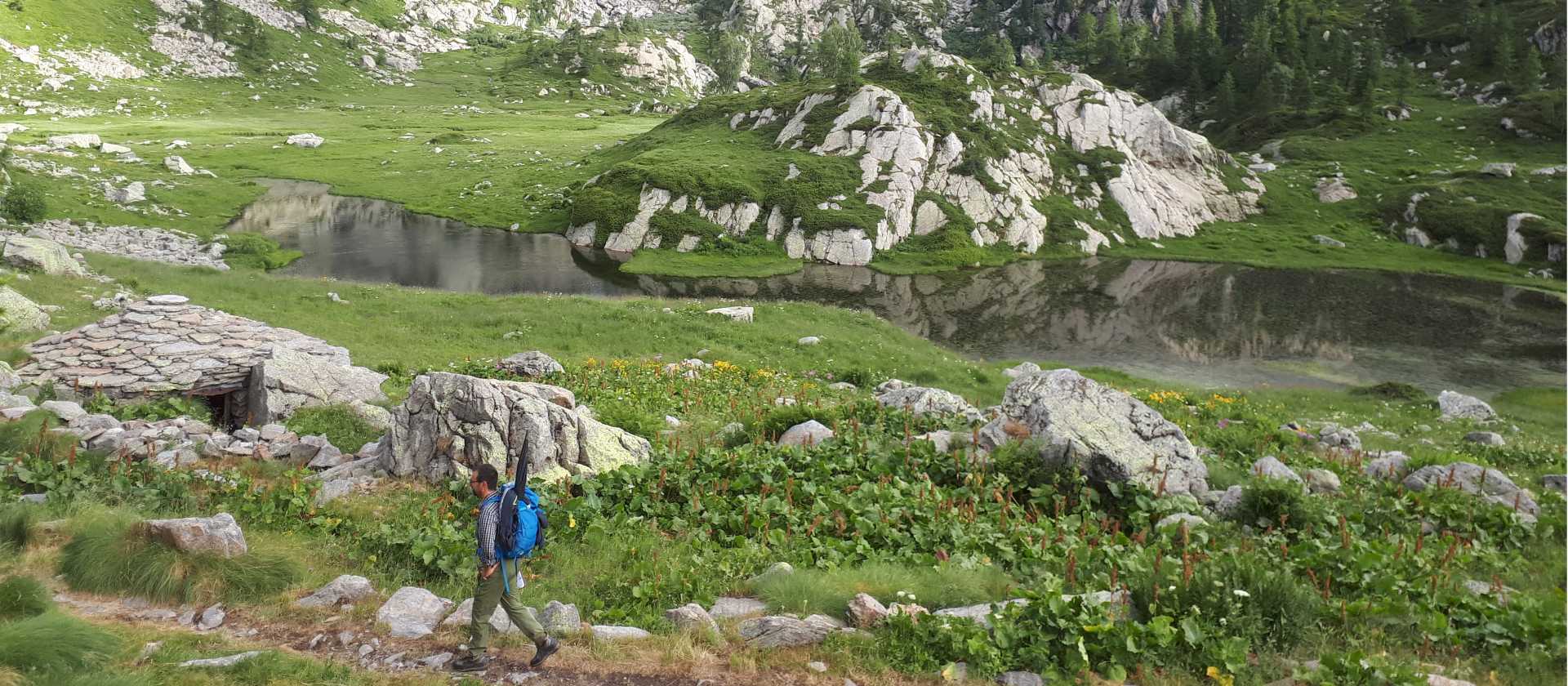 Walking past rugged mountainside on the Monte Rosa Alpine Walk