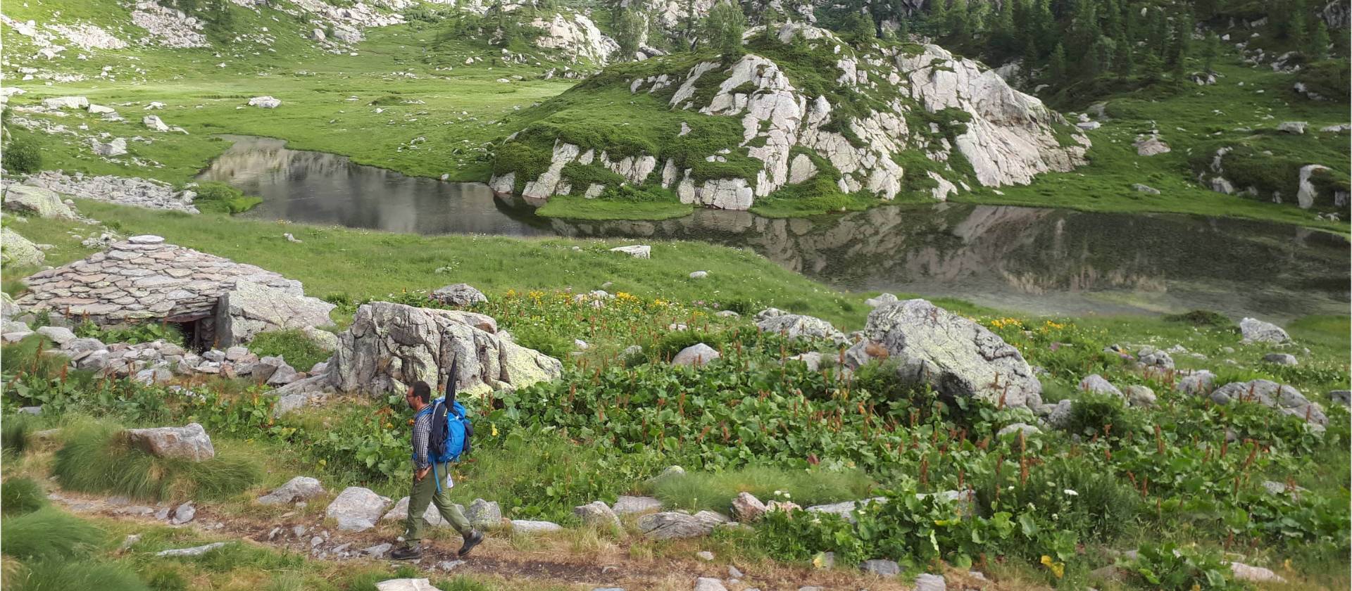 Walking past rugged mountainside on the Monte Rosa Alpine Walk
