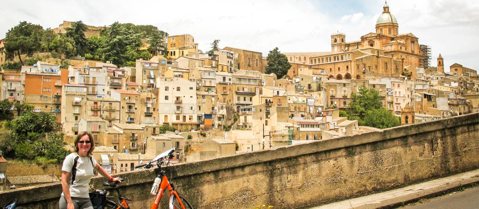 Cyclist with view to the historic heart of Caltagirone