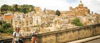 Cyclist with view to the historic heart of Caltagirone