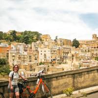 Cyclist with view to the historic heart of Caltagirone