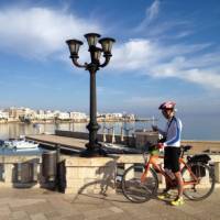 Cyclist on waterfront in Otranto | Kate Baker