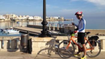 Cyclist on waterfront in Otranto