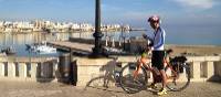 Cyclist on waterfront in Otranto | Kate Baker