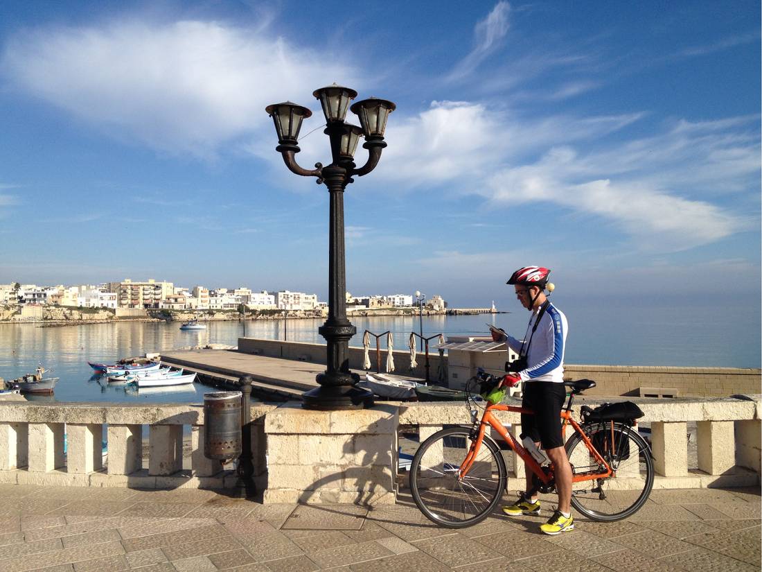 Cyclist on waterfront in Otranto |  <i>Kate Baker</i>