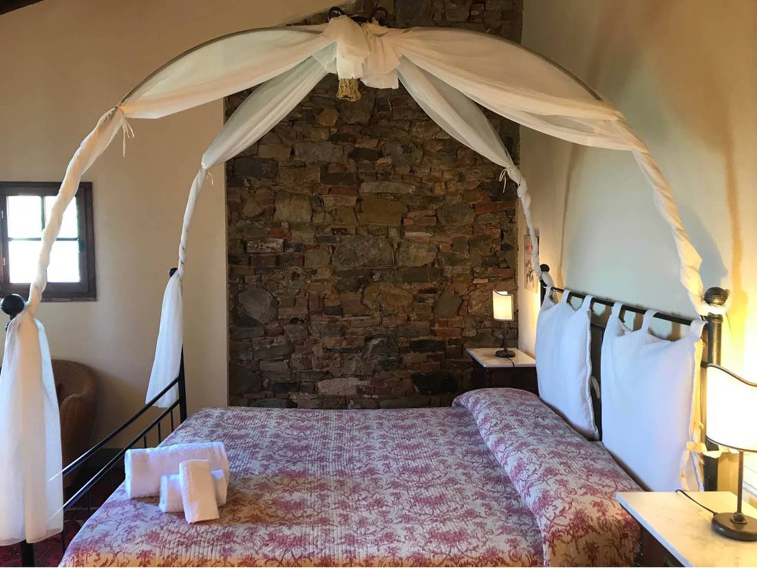 Canopy-covered bed in a charming handpicked agriturismo in Tuscany |  <i>Allie Peden</i>