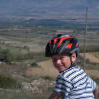 Child cycling through the countryside in Sardinia