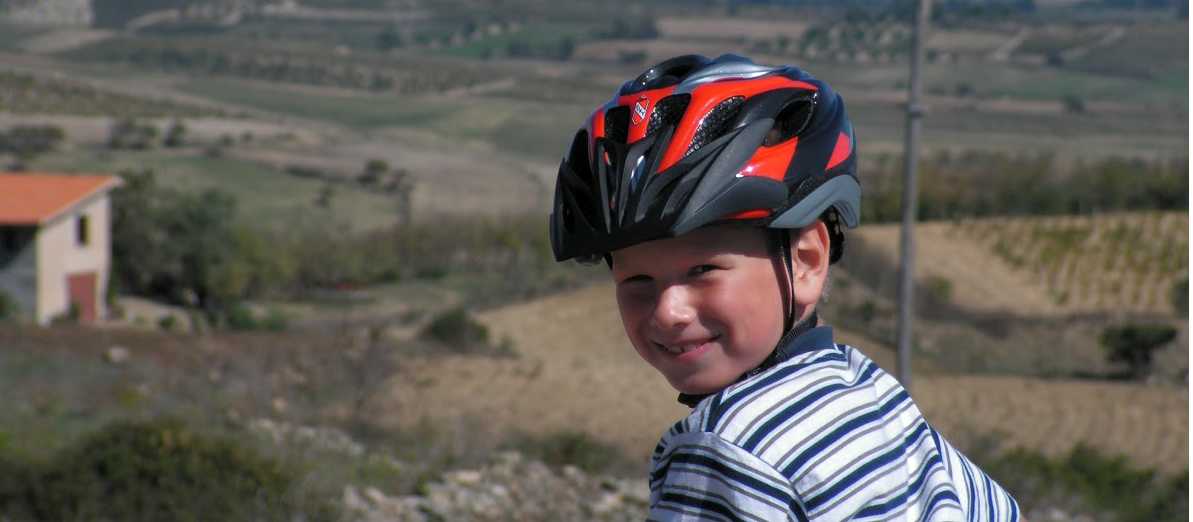 Child cycling through the countryside in Sardinia