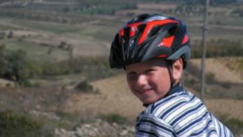 Child cycling through the countryside in Sardinia