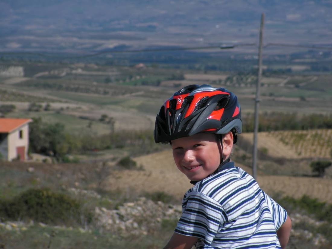 Child cycling through the countryside in Sardinia