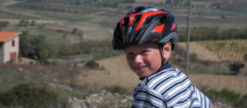 Child cycling through the countryside in Sardinia