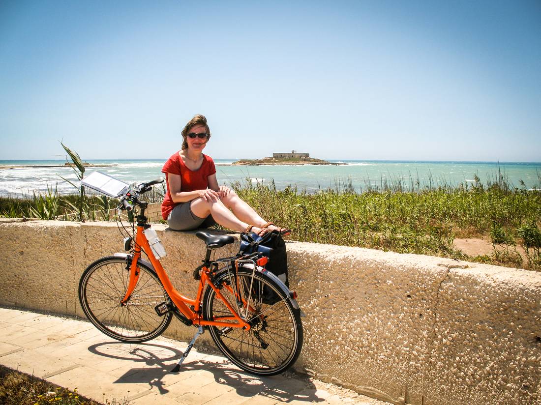 Cyclist taking a break while cycling the south eastern coast of Sicily